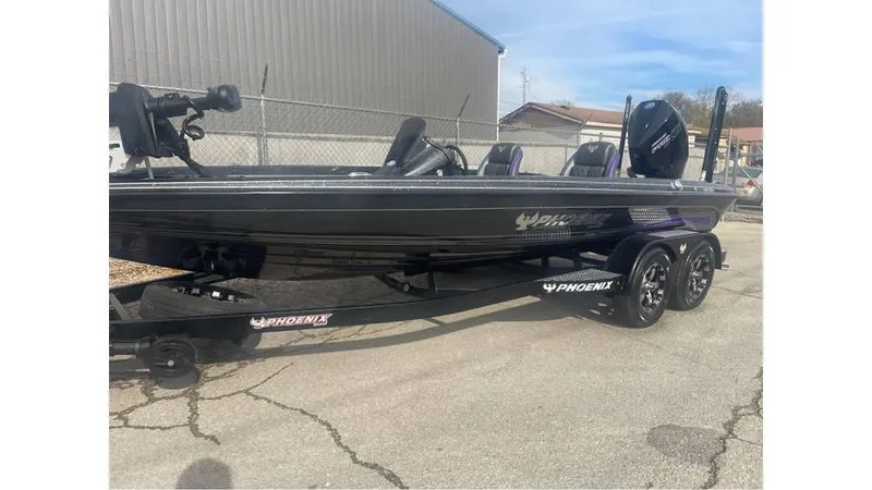 Slide: The Image of 2025 Phoenix 920 Elite boat on trailer, parked outdoors near a building. - 10