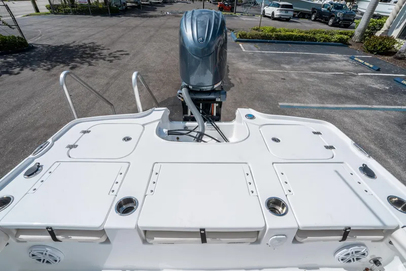 Slide: The Image of 2025 Sea Hunt BX 22 BR boat with outboard motor, viewed from the rear deck. - 10
