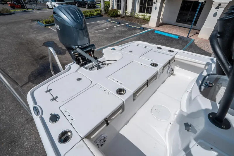Slide: The Image of 2025 Sea Hunt BX 22 BR boat with Yamaha outboard engine, parked in a lot. - 11