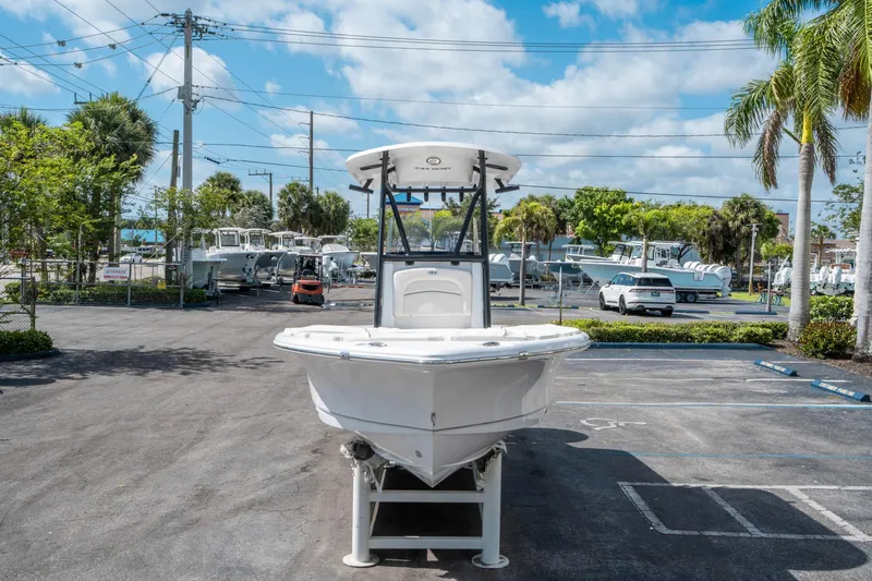 Slide: The Image of 2025 Sea Hunt BX 22 BR boat displayed in a sunny outdoor showroom. - 7