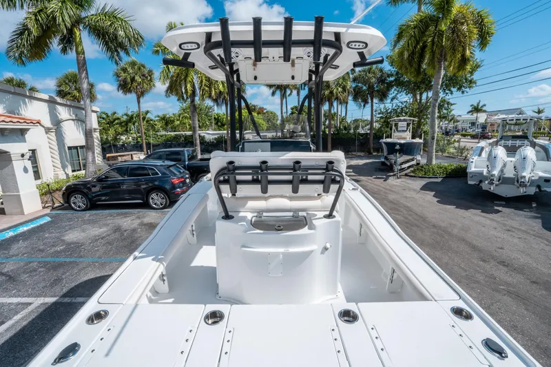 Slide: The Image of 2025 Sea Hunt BX 22 BR boat in a sunny parking lot with palm trees. - 9