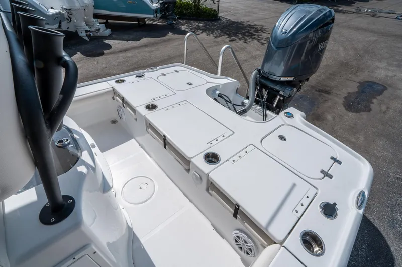 Slide: The Image of 2025 Sea Hunt BX 22 BR boat deck with Yamaha outboard motor, storage compartments, and rod holders. - 12