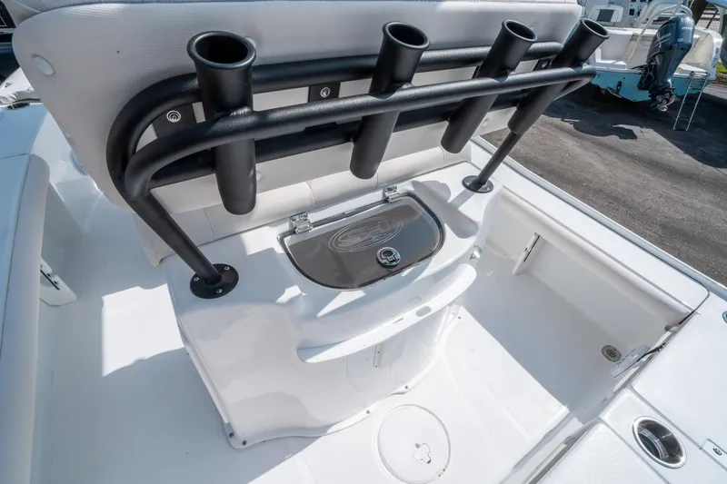 Slide: The Image of 2025 Sea Hunt BX 22 BR boat interior with rod holders and storage compartment. - 14