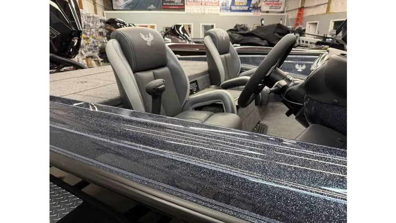 Slide: The Image of 2025 Phoenix 819 Pro boat interior with sleek seats and modern steering wheel. - 12