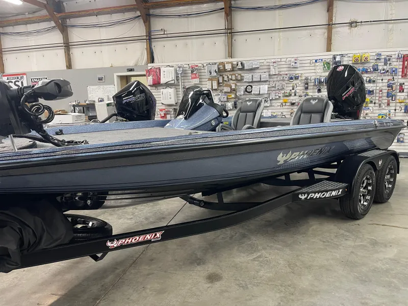 Slide: The Image of 2025 Phoenix 819 Pro boat in showroom, featuring sleek design and dual motors. - 2