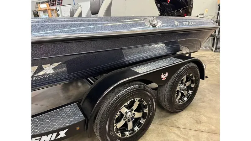 Slide: The Image of 2025 Phoenix 819 Pro boat on trailer, featuring sleek design and dual wheels. - 4