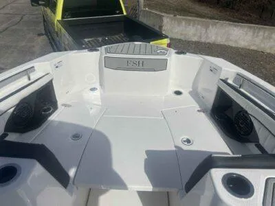 Slide: The Image of 2025 Yamaha Boats 252 FSH Sport bow area with seating and speakers. - 13
