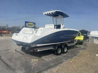 Slide: The Image of 2025 Yamaha Boats 252 FSH Sport on trailer, parked outdoors, side view. - 4