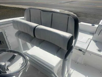 Slide: The Image of 2025 Yamaha Boats 252 FSH Sport helm seating with cushioned backrest and steering wheel. - 9