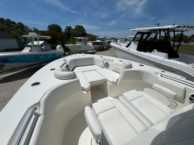Slide: The Image of 2025 Key West 291 FS boat with spacious seating, docked under a clear blue sky. - 3