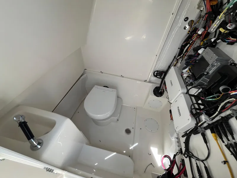 Slide: The Image of 2025 Key West 291 FS boat interior with toilet and electronic wiring. - 5