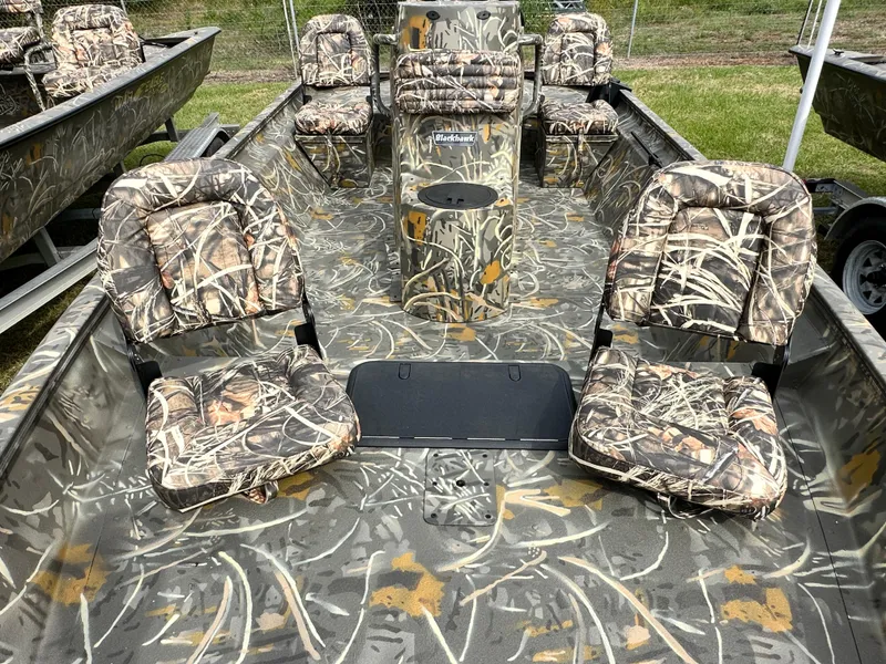 Slide: The Image of 2025 War Eagle 961 Blackhawk boat with camouflage seating and interior design. - 2