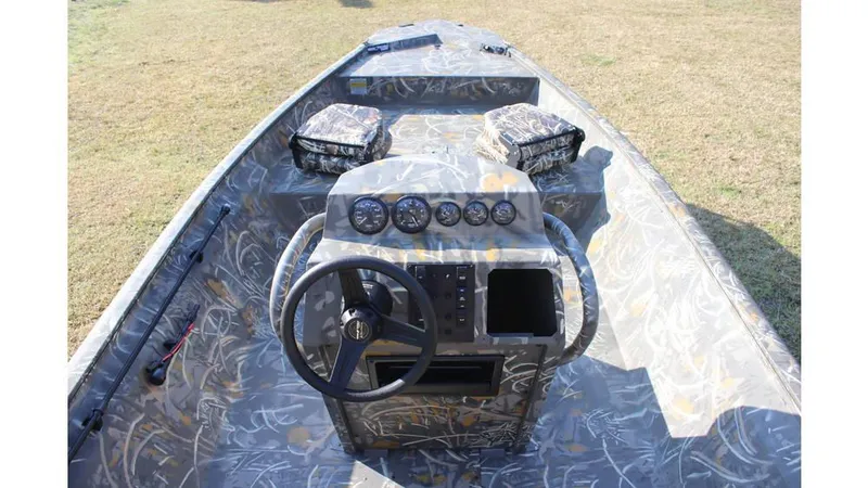 Slide: The Image of 2025 War Eagle 961 Blackhawk boat interior with camo design and control panel. - 9
