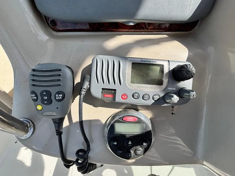 Slide: The Image of Control panel of a 2006 Sea Ray 320 Sundancer with radio and navigation equipment. - 12