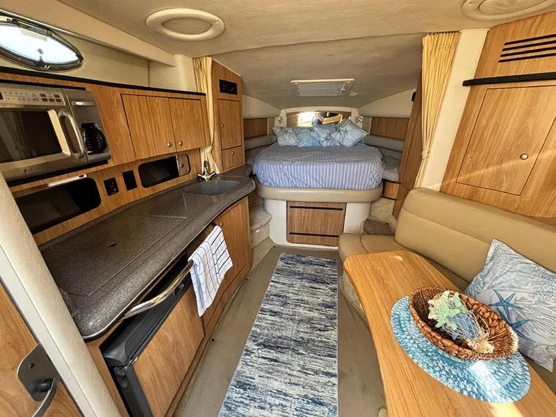 Slide: The Image of Interior of 2006 Sea Ray 320 Sundancer with kitchen, seating, and bed. - 15