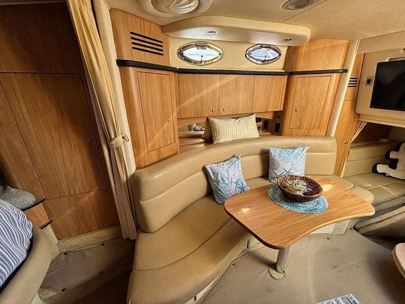 Slide: The Image of Interior of 2006 Sea Ray 320 Sundancer with cozy seating and wooden cabinetry. - 18