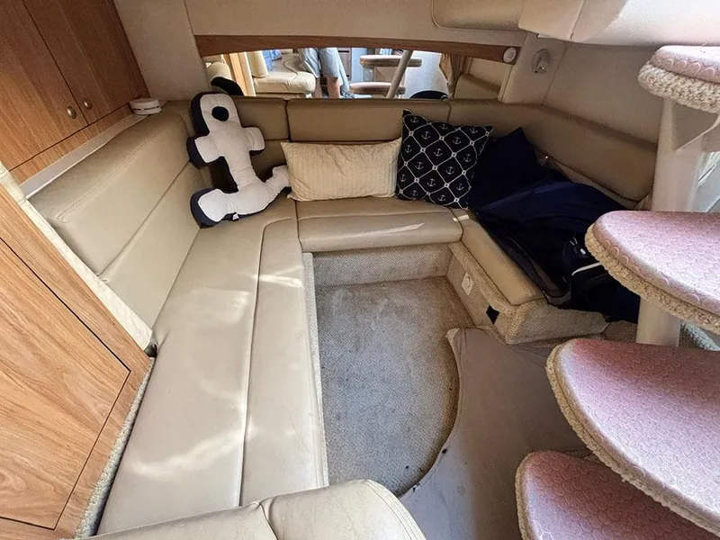 Slide: The Image of Interior of 2006 Sea Ray 320 Sundancer with beige seating and decorative pillows. - 19