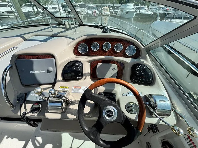 Slide: The Image of Helm of 2006 Sea Ray 320 Sundancer with gauges, controls, and Raymarine navigation system. - 4