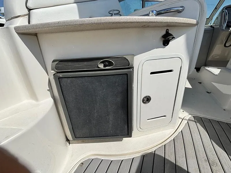 Slide: The Image of 2006 Sea Ray 320 Sundancer interior with storage compartments and control panel. - 5