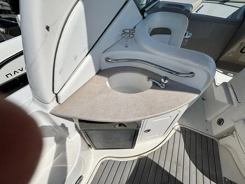 Slide: The Image of 2006 Sea Ray 320 Sundancer boat interior with sink and storage area. - 6