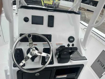 Slide: The Image of 2025 Yamaha Boats 222 FSH Sport dashboard with steering wheel and controls. - 12