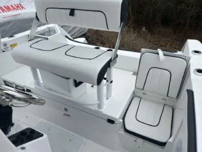 Slide: The Image of 2025 Yamaha Boats 222 FSH Sport interior seating with white and black upholstery. - 13