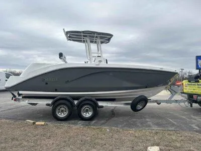 Slide: The Image of 2025 Yamaha Boats 222 FSH Sport on trailer, gray hull, parked outdoors. - 3