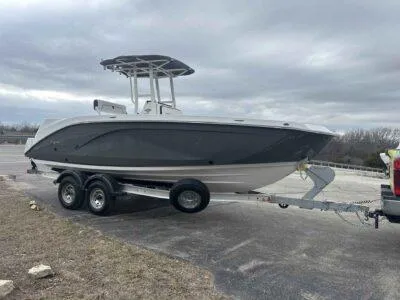 Slide: The Image of 2025 Yamaha Boats 222 FSH Sport on trailer, parked outdoors under cloudy sky. - 4