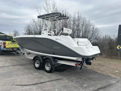 Slide: The Image of 2025 Yamaha Boats 222 FSH Sport on trailer, parked outdoors, overcast sky. - 5