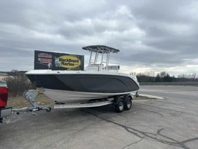 Slide: The Image of 2025 Yamaha Boats 222 FSH Sport on trailer, parked at BlackBeard Marine under cloudy skies. - 7