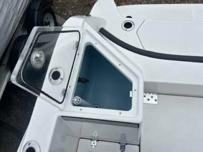 Slide: The Image of 2025 Yamaha Boats 222 FSH Sport, open storage compartment, sleek design, white finish. - 8