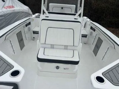 Slide: The Image of 2025 Yamaha Boats 222 FSH Sport interior, featuring sleek white seating and modern design. - 9