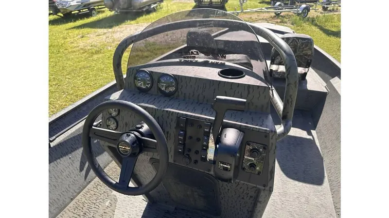Slide: The Image of 2025 War Eagle 2170 Blackhawk boat interior with steering wheel and control panel. - 5