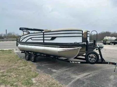 Slide: The Image of 2025 Lowe SS 210 WT pontoon boat on trailer, parked outdoors. - 5