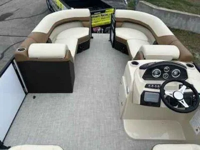 Slide: The Image of 2025 Lowe SS 210 WT pontoon boat interior with plush seating and modern helm. - 7