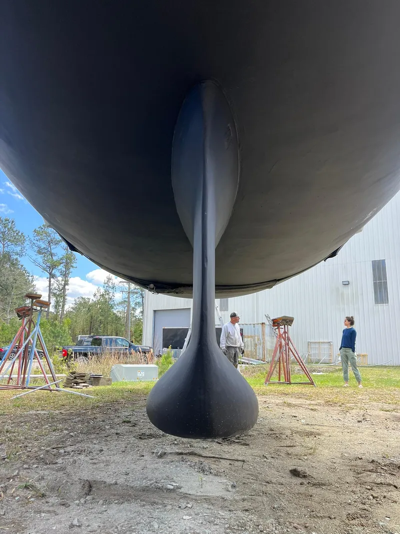 Slide: The Image of 2007 Beneteau 423 sailboat keel, dry docked, with people inspecting. - 11