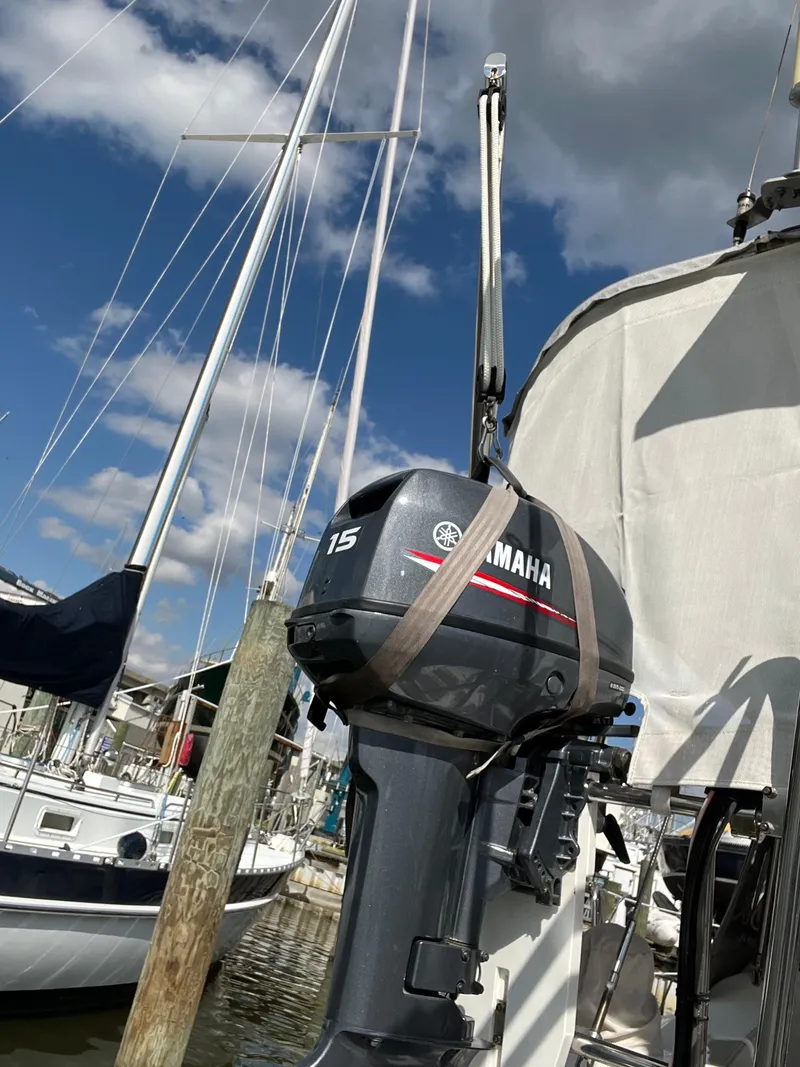 Slide: The Image of Yamaha outboard motor on a 2007 Beneteau 423 sailboat, docked under a blue sky. - 14