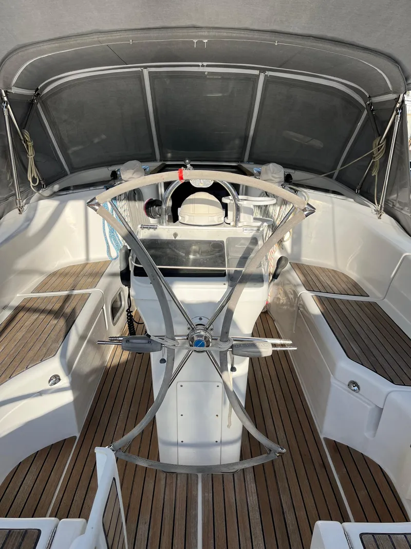Slide: The Image of 2007 Beneteau 423 sailboat cockpit with dual steering wheels and teak flooring. - 17