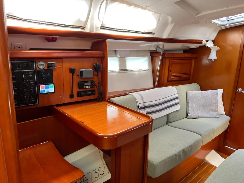 Slide: The Image of Interior of 2007 Beneteau 423 sailboat with cozy seating and navigation station. - 22