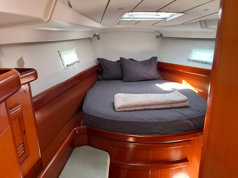 Slide: The Image of Cozy cabin interior of 2007 Beneteau 423 sailboat with bed and wooden finish. - 24