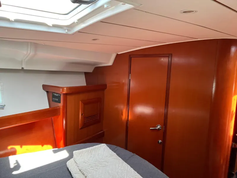 Slide: The Image of Interior cabin of 2007 Beneteau 423 yacht with wooden finish and skylight. - 25