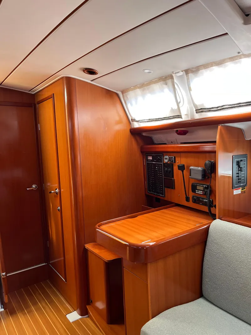 Slide: The Image of Interior of 2007 Beneteau 423 sailboat with wood paneling and navigation equipment. - 26