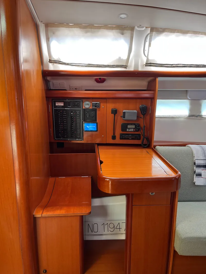 Slide: The Image of 2007 Beneteau 423 yacht interior with navigation station and control panel. - 27