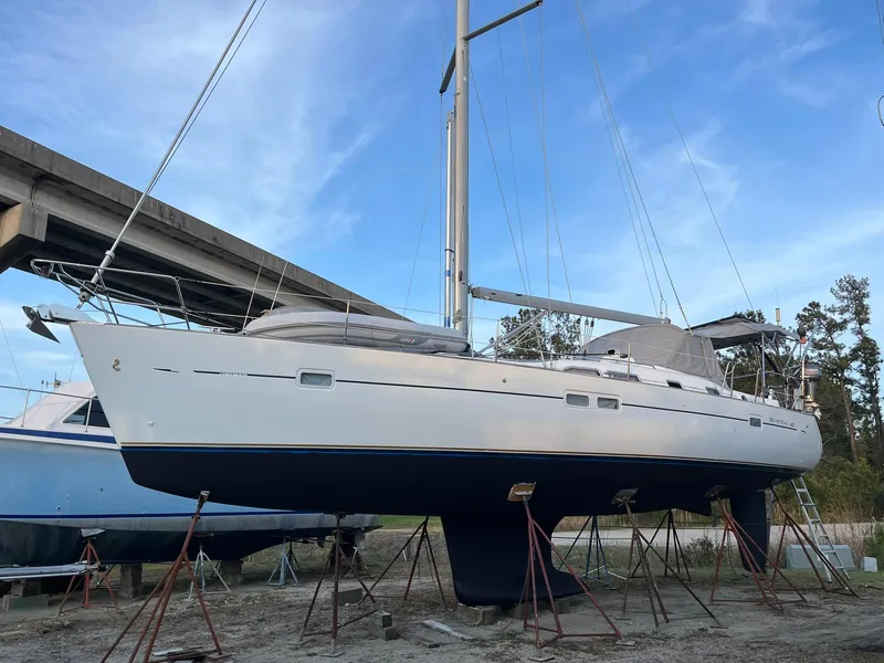 Slide: The Image of 2007 Beneteau 423 sailboat on stands, ready for maintenance under a clear blue sky. - 6