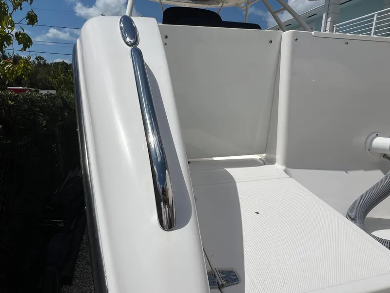 Slide: The Image of 2016 Pursuit S 280 Sport boat deck with chrome railing under clear sky. - 12