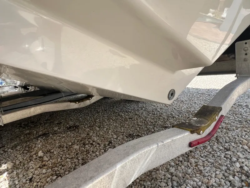 Slide: The Image of 2016 Pursuit S 280 Sport boat on trailer, close-up view of hull and trailer. - 14