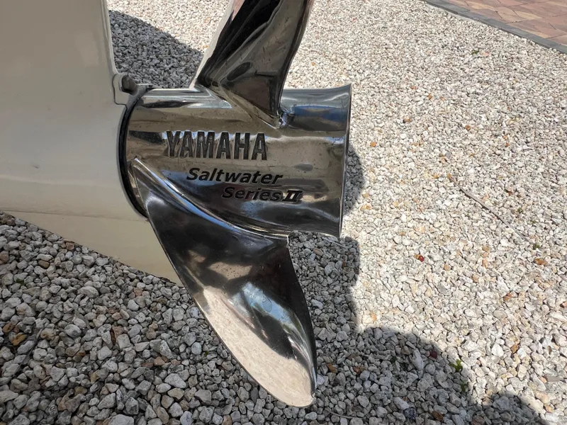 Slide: The Image of Yamaha Saltwater Series II propeller on 2016 Pursuit S 280 Sport boat, gravel background. - 18
