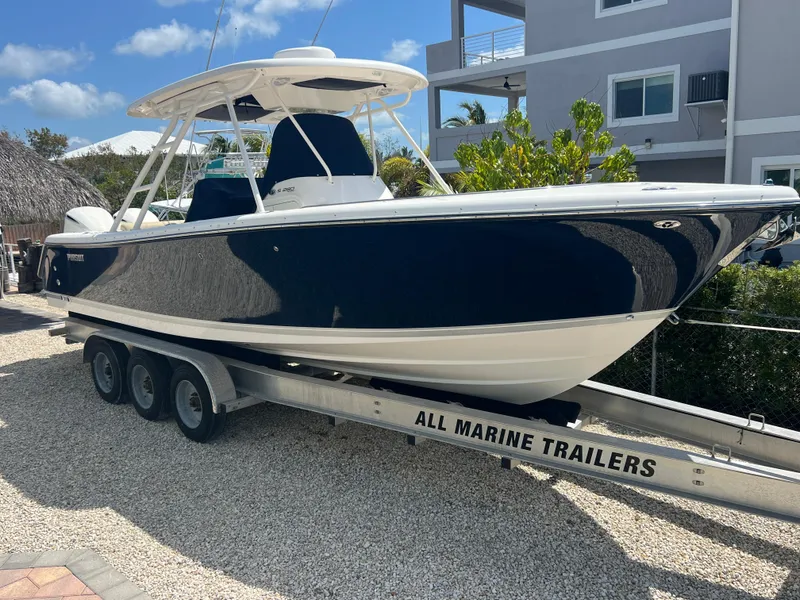 Slide: The Image of 2016 Pursuit S 280 Sport boat on trailer, parked outdoors. - 2