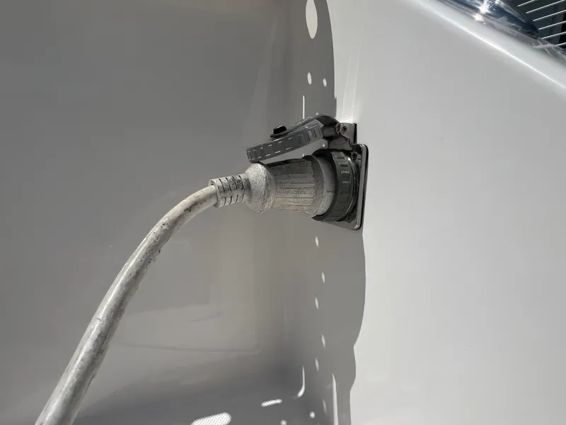 Slide: The Image of Power cable plugged into 2016 Pursuit S 280 Sport boat outlet. - 20