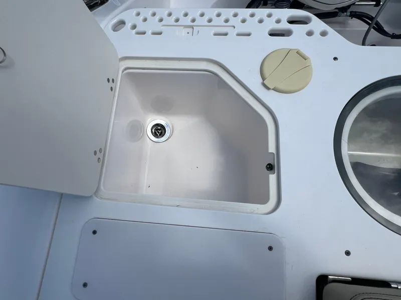 Slide: The Image of 2016 Pursuit S 280 Sport boat sink and storage compartment. - 25